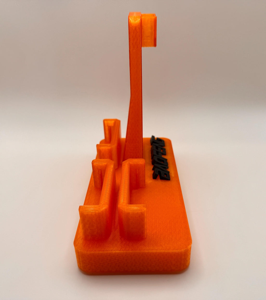 Baofeng UV-5R 25th anniversary transparent orange desk stand – battery slots angled