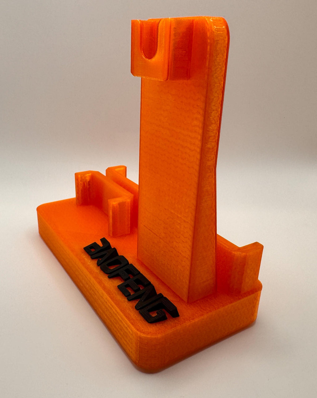 Baofeng UV-5R 25th anniversary transparent orange desk stand – empty stand side view