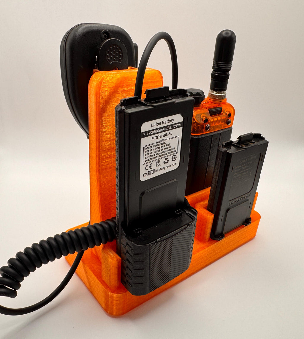 Baofeng UV-5R 25th anniversary transparent orange desk stand – rear view with batteries