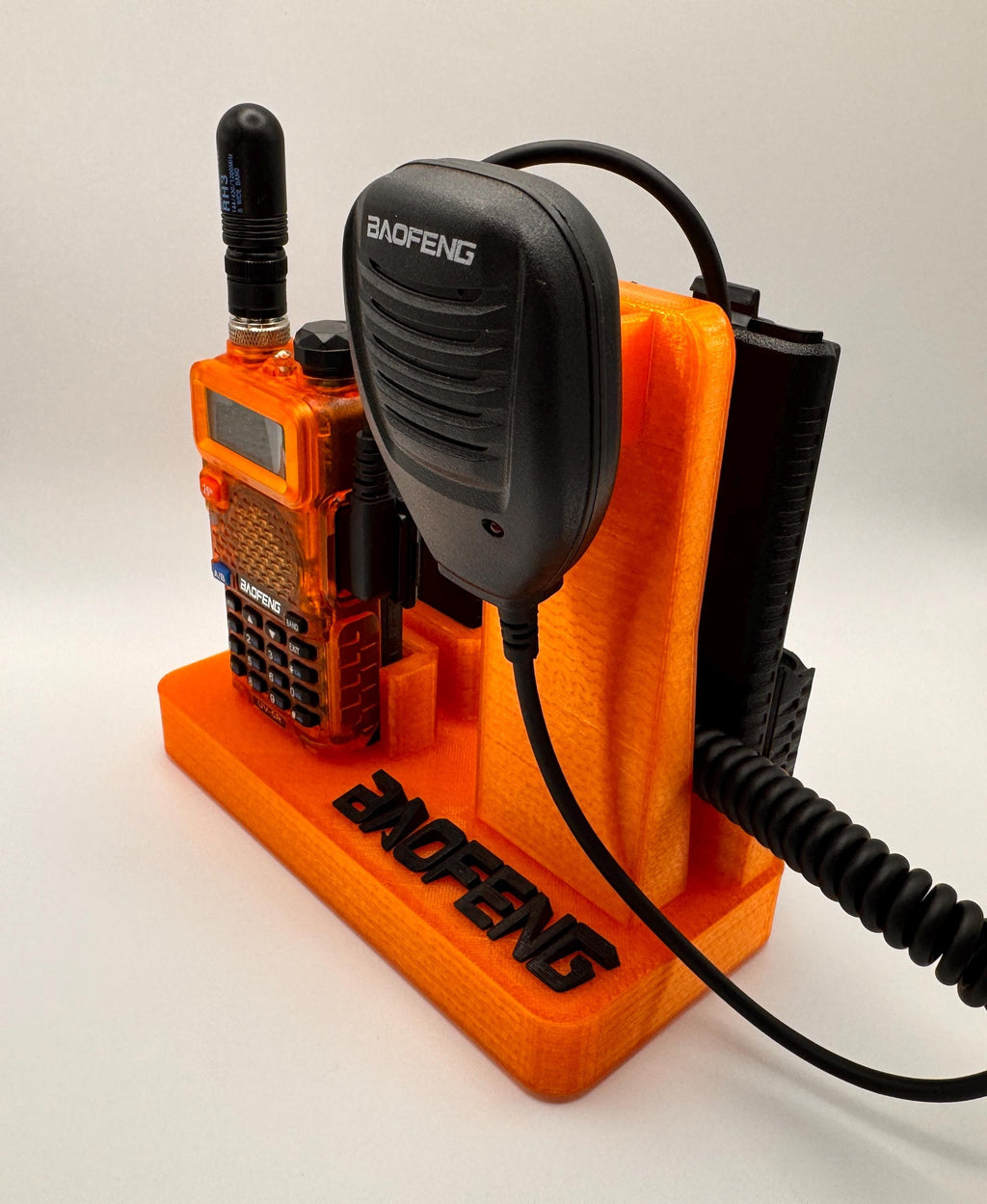 Baofeng UV-5R 25th anniversary transparent orange desk stand – side view with mic