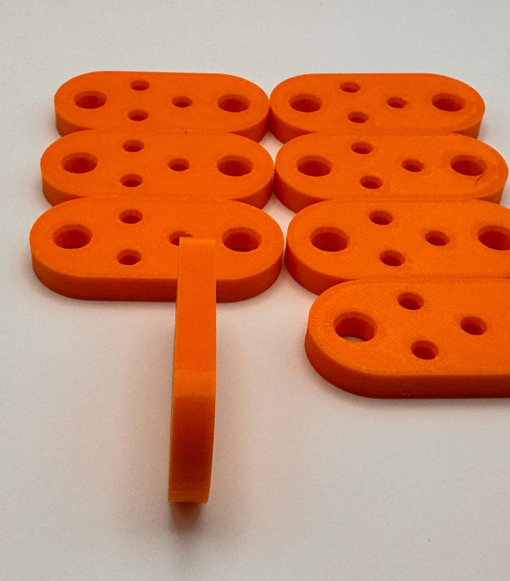 Flat 5-Hole Antenna Wire Insulators – insulator standing on edge to show thickness