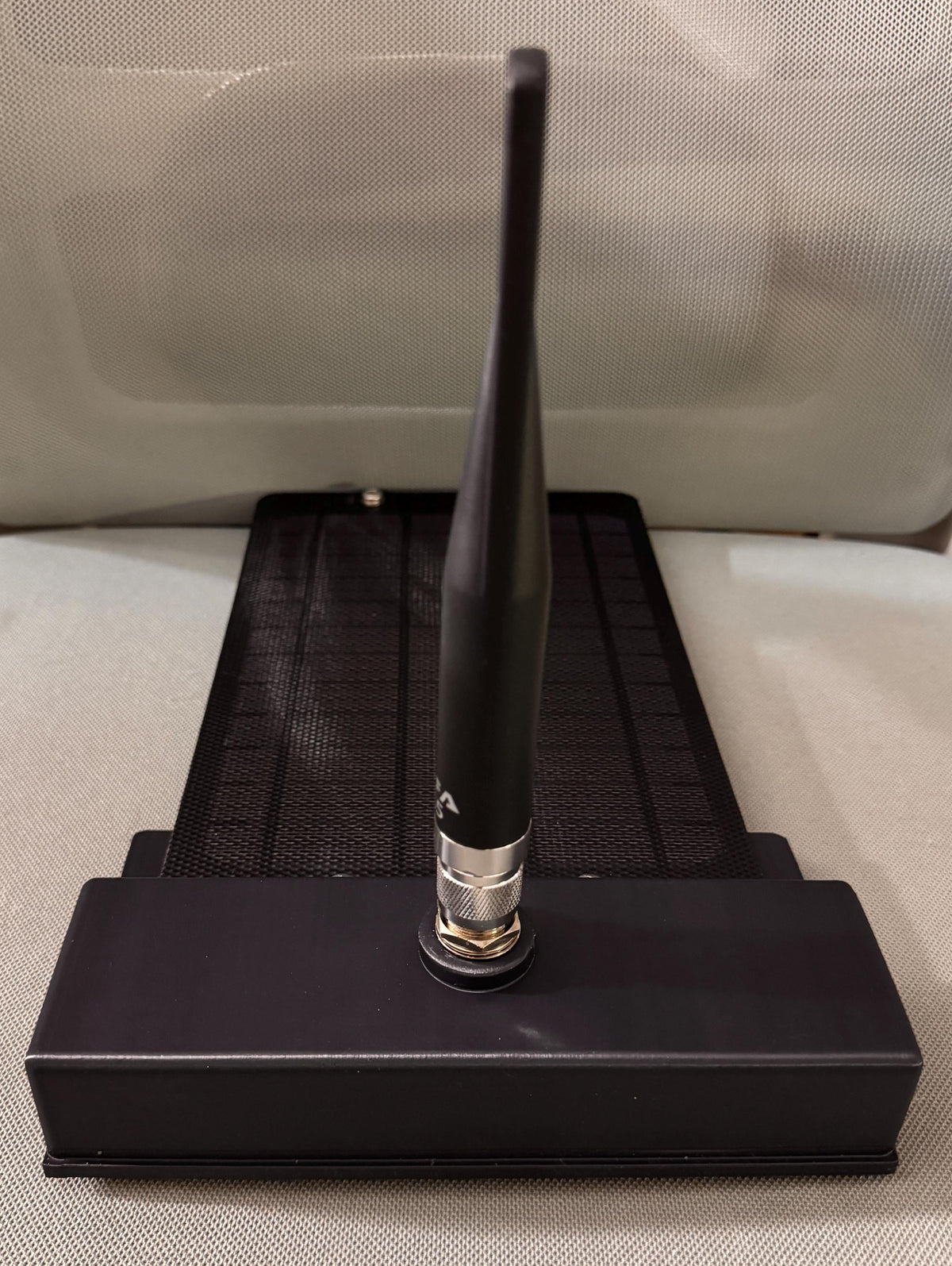 Meshtastic solar node housing – assembled node with antenna, low angle